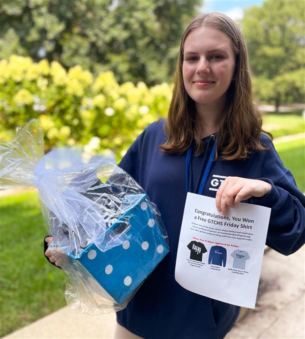 Lilly Fuller, Winner of the PIP Membership Swag Basket, including the GTCHS Paint Drip Shirt as her prize.